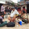 People take refuge at a school after a 7.7 magnitude earthquake struck in Kathmandu