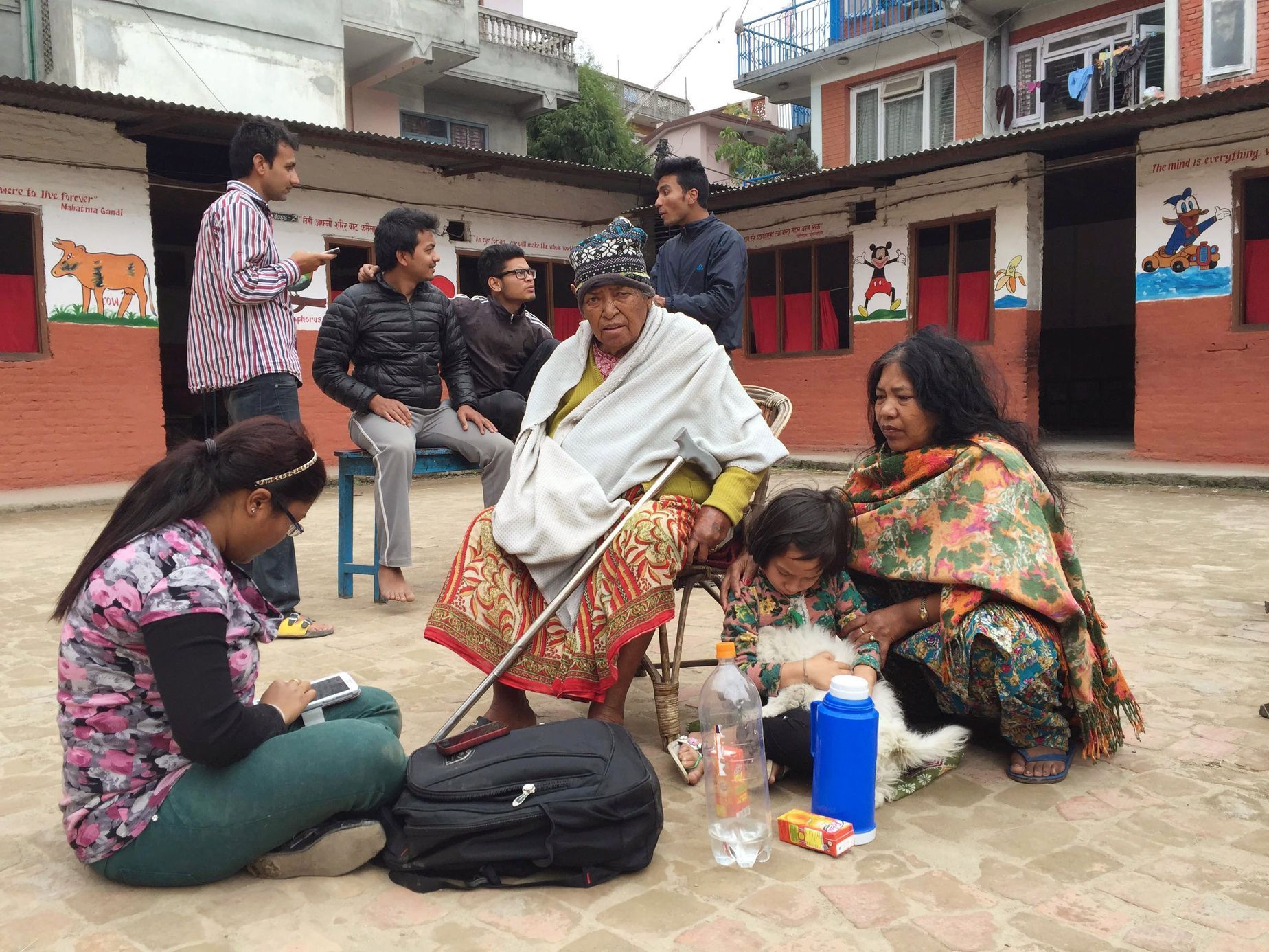 People take refuge at a school after a 7.7 magnitude earthquake struck in Kathmandu