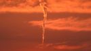 Twister with a twist in desert - (PICTURED: AEROPLANE TRAIL TORNADO IN THE SAUDI ARABIAN DESERT) - This is the moment a huge tornado appeared to be forming to rip across the middle of the desert. This stunning image appears to show the swirling wind gathering speed in front of the magnificent sunset. But while people sitting in the desert began to panic, it became clear that the super storm was in fact an AEROPLANE TRAIL. Amateur photographer Tariq Almutlaq, 45, was picnicking in the Saudi Arabian desert near Riyadh with his family, when people began to point at the sky. Fearing a tornado was imminent, they went to return to their cars - before realising that the twisted tunnel was nothing more than a jet trail.