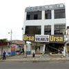 A man walks by a damaged building after an earthquake struck off Ecuador's Pacific coast, at Tarqui neighborhood in Manta