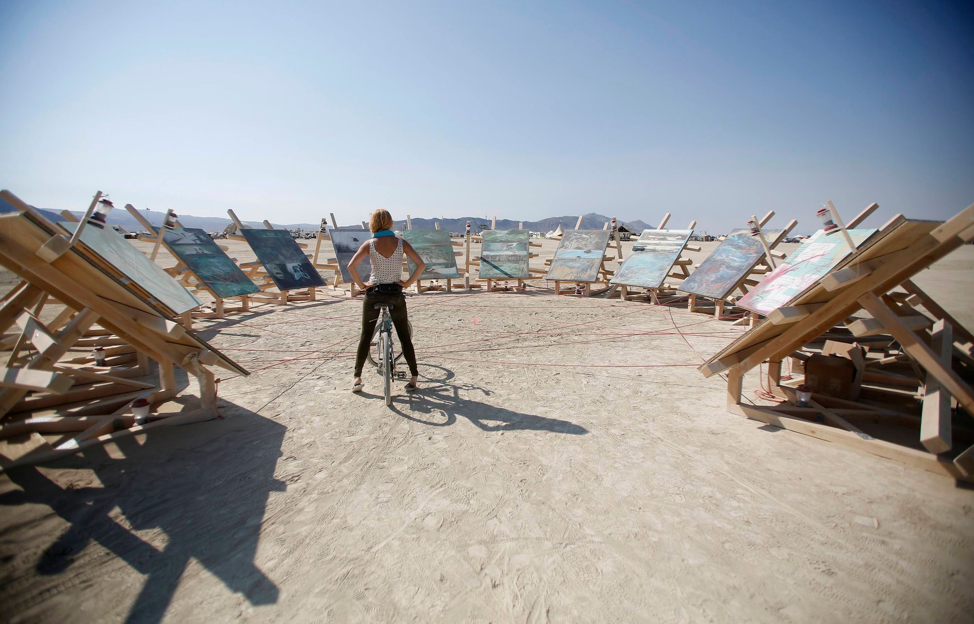 Lacey Redd examines an art installation on the last day of the Burning Man 2014 &quot;Caravansary&quot; arts and music festival in the Black Rock Desert of Nevada