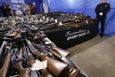 Tables covered with guns area seen Tuesday, Jan. 29, 2013, in Trenton, N.J., during a display of 2,600 guns, including 700 that were illegal, that were turned in last Friday and Saturday during a gun buyback program in the state's capital. (AP Photo/Mel Evans)