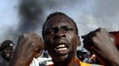 A man gestures at a market burnt in an air strike by the Sudanese air force in Rubkona