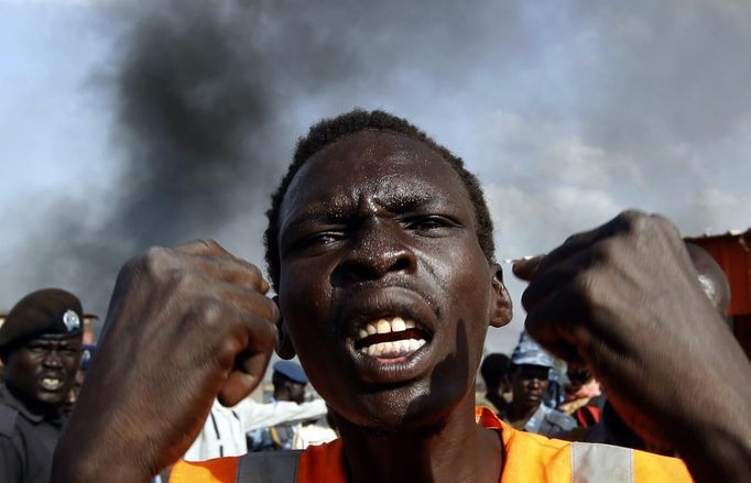 A man gestures at a market burnt in an air strike by the Sudanese air force in Rubkona