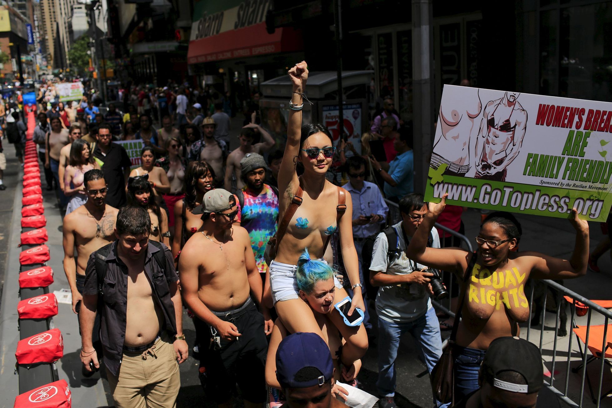 People take part in a topless march in New York