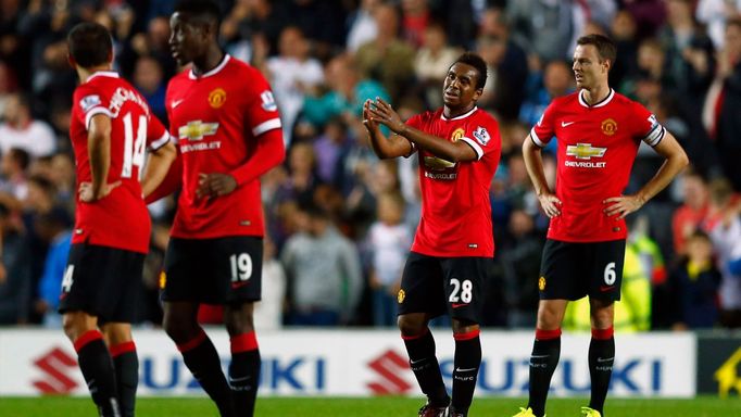 Manchester United's Anderson and Evans react after Grigg of Milton Keynes Dons scored their second goal during their League Cup soccer match at stadiummk in Milton Keynes