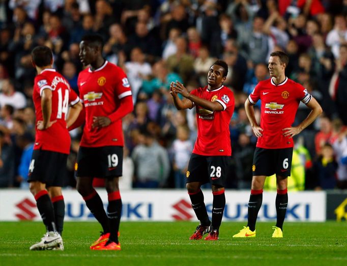 Manchester United's Anderson and Evans react after Grigg of Milton Keynes Dons scored their second goal during their League Cup soccer match at stadiummk in Milton Keynes