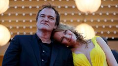 Director Quentin Tarantino and actress Uma Thurman pose on the red carpet they arrive for the screening of the film &quot;Sils Maria&quot; in competition at the 67th Cannes Film Festival in Cannes
