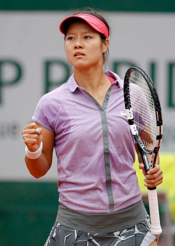 Li Na of China reacts during her women's singles match against Kristina Mladenovic of France at the French Open tennis tournament at the Roland Garros stadium in Paris Ma