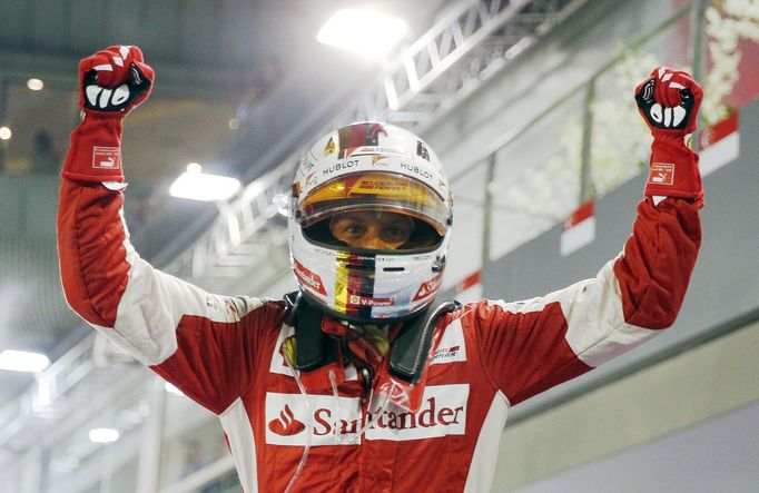 Ferrari Formula One driver Sebastian Vettel of Germany reacts after winning the Singapore F1 Grand Prix at the Marina Bay street circuit September 20, 2015. REUTERS/Edgar