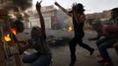 Palestinian youths throw stones towards Israeli border police (not seen) in the Shuafat refugee camp in the West Bank near Jerusalem September 18, 2012. Clashes between police and protesters erupted following a protest against a film mocking the Prophet Mohammad. REUTERS/Ammar Awad (JERUSALEM - Tags: POLITICS CIVIL UNREST TPX IMAGES OF THE DAY) Published: Zář. 18, 2012, 5:52 odp.