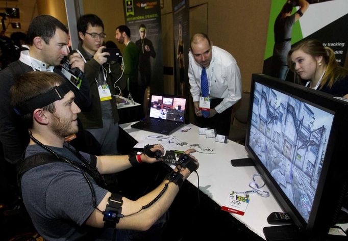 YEI Technology's Chris George plays a computer game with PrioVR, a virtual reality gaming accessory, during &quot;CES Unveiled,&quot; a media preview event to the annual