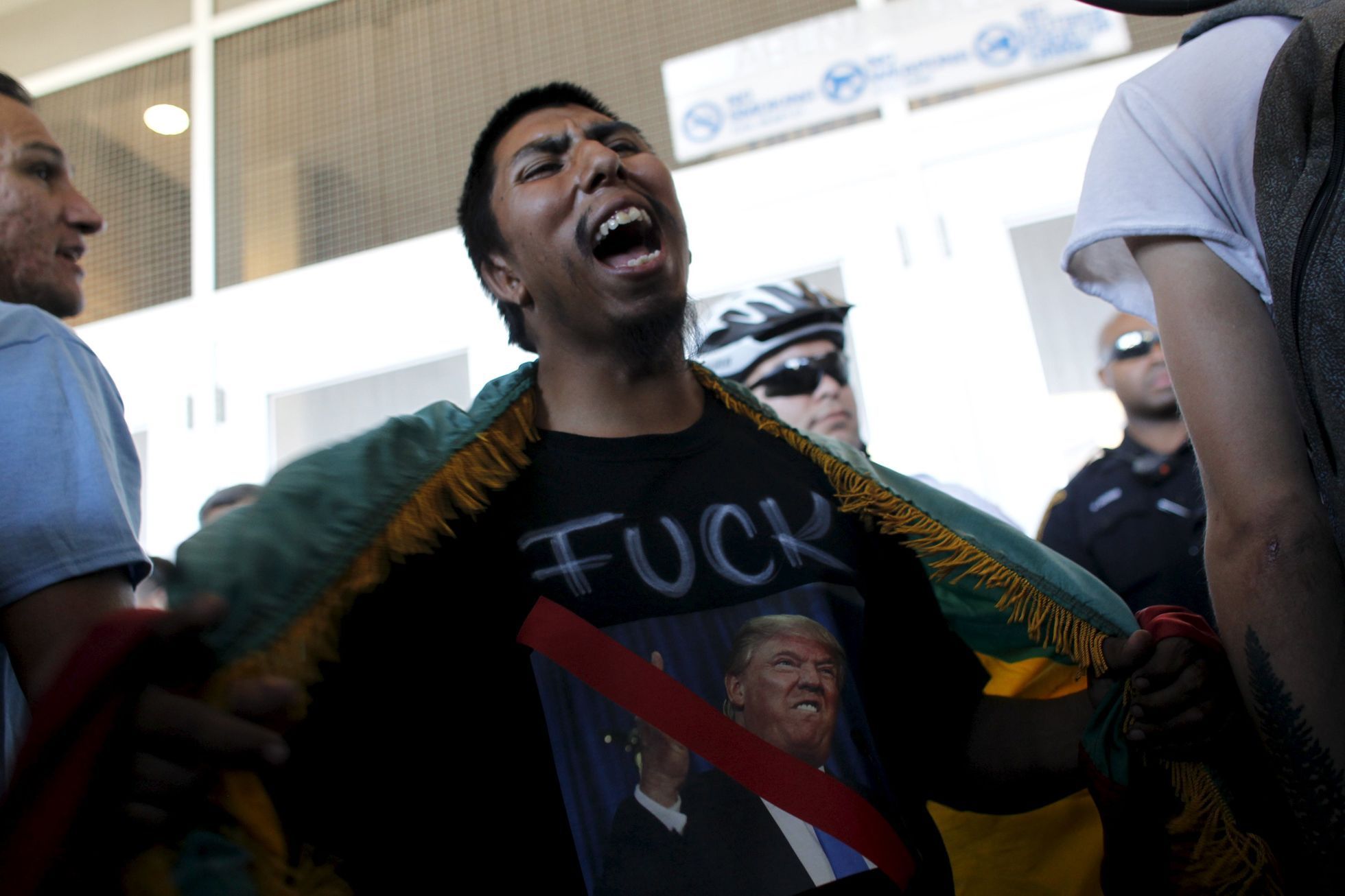 A demonstrator against Republican U.S. presidential candidate Donald Trump protests during a Trump campaign rally in Tucson, Arizona