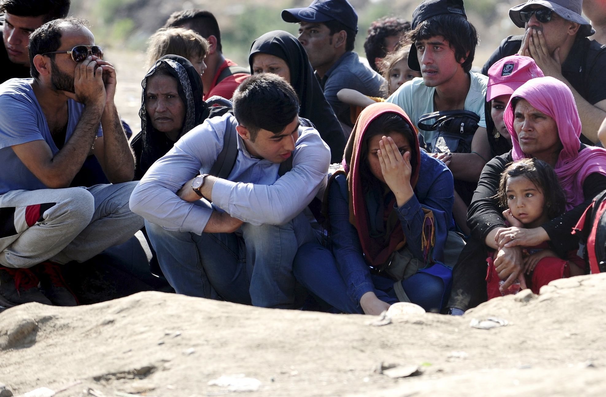 Migrants wait on the Greek side of the border to enter Macedonia near Gevgelija, Macedonia, en route to northern Europe