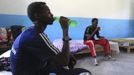 Somali athletes drink water and rest inside their room after training during preparations for the 2012 London Olympic Games in Somalia's capital Mogadishu in this March 14, 2012 file photo. Training in a bullet-riddled stadium where the remains of a rocket propelled grenade lies discarded on the track's edge counts as progress for Somali Olympic hopeful Mohamed Hassan Mohamed. A year ago, Mogadishu's Konis stadium was a base for Islamist militants and a work out meant at times running through the streets, dodging gun-fire and mortar shells in one of the world's most dangerous cities. To match OLY-SOMALIA-HOPES/ REUTERS/Feisal Omar/Files (SOMALIA - Tags: SPORT ATHLETICS SOCIETY OLYMPICS) Published: Čer. 11, 2012, 6:55 dop.