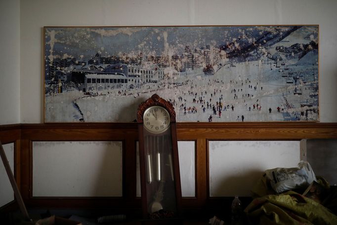 A poster of the snow-covered resort hangs on a wall at the abandoned Alps Ski Resort