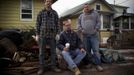 Friends (L-R) Joseph Ciavardone, Bobby Rasmussen and Carlo Loporto, who have been friends and neighbours since they where children living in New Dorp Beach, Staten Island, pose together as they take a break from gutting out the flooded remains of Ciavardone's home November 14, 2012. All three men had their homes completely flooded when Hurricane Sandy hit but they plan to stay in the area where they were born and raised. Picture taken November 14, 2012. REUTERS/Mike Segar (UNITED STATES - Tags: DISASTER ENVIRONMENT) ATTENTION EDITORS PICTURE 07 OF 19 FOR PACKAGE 'SURVIVING SANDY' SEARCH 'SEGAR SANDY' FOR ALL PICTURES Published: Lis. 20, 2012, 3:30 odp.