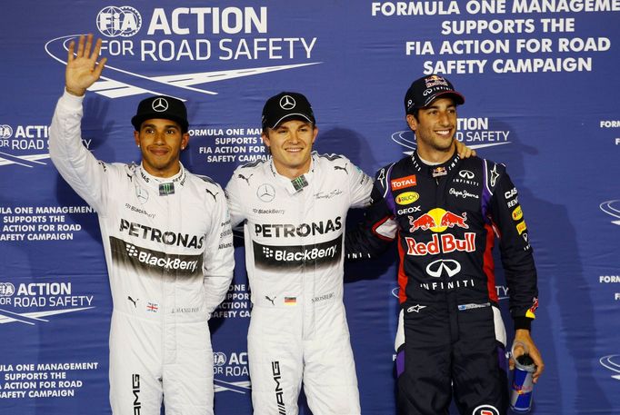 Mercedes Formula One driver Nico Rosberg of Germany (C) celebrates after taking pole position at the qualifying session of the Bahrain F1 Grand Prix at the Bahrain Intern