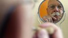 A participant is reflected on a mirror as he gets ready for the 2012 European Beard and Moustache Championships in Wittersdorf near Mulhouse, Eastern France, September 22, 2012. More than a hundred participants competed in the first European Beard and Moustache Championships organized in France. REUTERS/Vincent Kessler (FRANCE - Tags: SOCIETY) Published: Zář. 22, 2012, 7:20 odp.