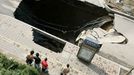 People look at a sinkhole People look at a sinkhole in a street in Taiyuan in north China's Shanxi province Thursday Aug. 12, 2010. Part of a hospital building beside it collapsed later but no one was killed in it.