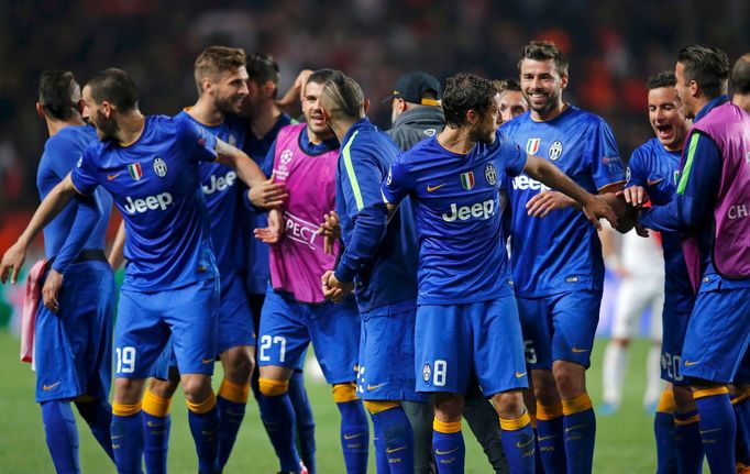 Juventus players celebrate after their team's qualification for the semi-final of the Champions League at the end of their quarter-final second leg soccer match against M