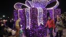 People enjoy the Christmas illuminations at the Royal Treaty street in Warsaw, Poland, Saturday, Dec. 1, 2012. (AP Photo/Czarek Sokolowski)