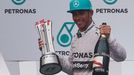 Mercedes Formula One driver Lewis Hamilton of Britain celebrates on the podium after winning the Malaysian F1 Grand Prix at Sepang International Circuit outside Kuala Lum