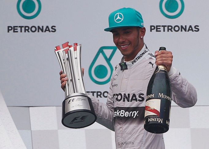 Mercedes Formula One driver Lewis Hamilton of Britain celebrates on the podium after winning the Malaysian F1 Grand Prix at Sepang International Circuit outside Kuala Lum