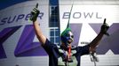 A Seattle Seahawks fan celebrates while awaiting the start of the NFL Super Bowl XLIX football game against the New England Patriots outside of the stadium in Glendale, A