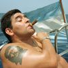 FILE PHOTO: Argentine soccer star Diego Maradona smokes a Cohiba as he rides a sailboat