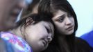 Mary Hamilton (L) puts her head on the shoulder of her friend Stephanie Rodriquez during a vigil for victims behind a theater where a gunman open fire on moviegoers in Aurora, Colorado July 20, 2012. A total of 71 people were shot in Friday's rampage at the Denver-area movie theater that has left 12 people dead, the local police chief said. The suspect, identified by police as James Eagan Holmes, 24, also booby-trapped his Aurora apartment with sophisticated explosives, creating a hazard for law-enforcement and bomb squad officers who swarmed to the scene. REUTERS/ Jeremy Papasso (UNITED STATES - Tags: CRIME LAW TPX IMAGES OF THE DAY) Published: Čec. 21, 2012, 3:48 dop.