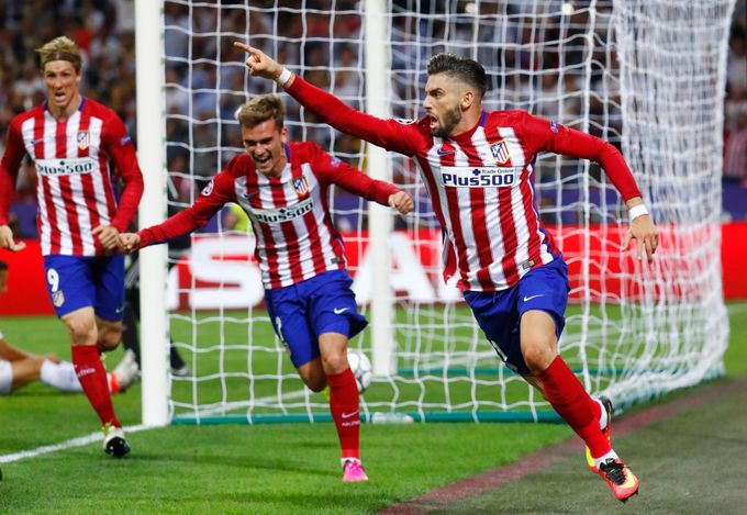 Yannick Ferreira Carrasco celebrates with Antoine Griezmann (C) and Fernando Torres (L) after scoring the first goal for Atletico Madrid