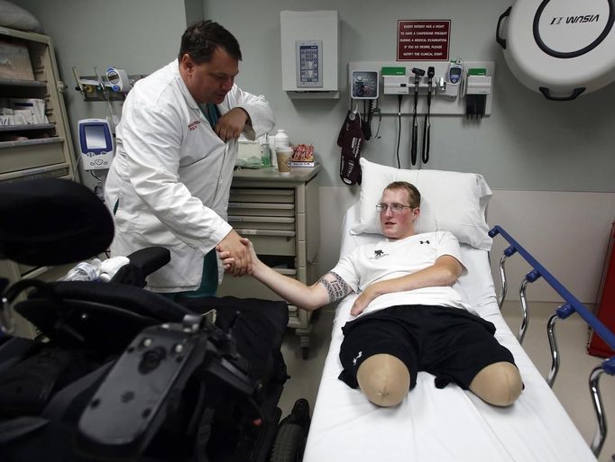 Sgt. Matt Krumwiede of the U.S. Army reacts as his hand is massaged by his mother Pam Krumwiede, after being admitted for an infection at Brooke Army Medical Center in San Antonio, Texas November 4, 2013. On June 12, 2012, Krumwiede was on patrol in Afghanistan when he stepped on an IED, which tore away both his legs, damaged his left arm, and ripped open his abdominal cavity. The 22-year-old has since undergone around 40 surgeries and is learning to walk with prosthetic legs. He is keen to re-join the infantry as soon as his injuries allow. U.S. troops have been in Afghanistan since 2001. Thousands of Afghan elders gathered in Kabul on November 21, 2013 at a Loya Jirga, or grand council, to debate a crucial security pact with the United States, a day after Kabul and Washington reached a draft agreement laying out the terms under which U.S. troops may stay beyond 2014. Picture taken November 4, 2013.