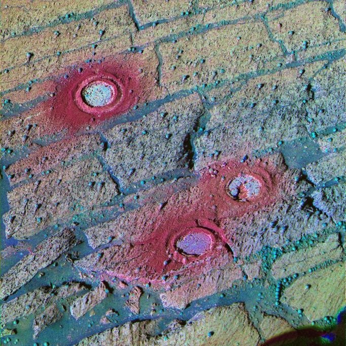 Three Fresh Exposures, Stretched Color 7/1/04 This panoramic camera image from NASA's Mars Exploration Rover Opportunity has been processed using a technique known as a decorrelation stretch to exaggerate the colors. The area in the image includes three holes created inside "Endurance Crater" by Opportunity's rock abrasion tool between sols 143 and 148 (June 18 and June 23, 2004). Because color variations are so subtle in the pictured area, stretched images are useful for discriminating color differences that can alert scientists to compositional and textural variations. For example, without the exaggeration, no color difference would be discernable among the tailings left behind after the grinding of these holes, but in this stretched image, the tailings around "London" (top) appear more red than those of the other holes ("Virginia," middle, and "Cobble Hill," bottom). Scientists believe that is because the rock abrasion tool sliced through two "blueberries," or spherules (visible on the upper left and upper right sides of the circle). When the blades break up these spherules, composed of mostly gray hematite, the result is a bright red powder. In this image, you can see the rock layers that made the team want to grind holes in each identified layer. The top layer is yellowish red, the middle is yellowish green and the lower layer is green. Another advantage to viewing this stretched image is the clear detail of the distribution of the rock abrasion tool tailings (heading down-slope) and the differences in rock texture. This image was created using the 753-, 535- and 432-nanometer filters. Image Credit: NASA/JPL/Cornell