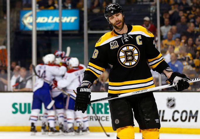 May 14, 2014; Boston, MA, USA; Boston Bruins defenseman Zdeno Chara (33) skates away as the Montreal Canadiens celebrate after Chara deflected a shot into his own goal du