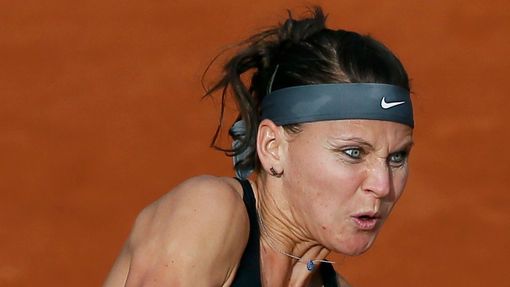 Lucie Safarova of the Czech Republic hits a return to Mandy Minella of Luxembourg during their women's singles match at the French Open tennis tournament at the Roland Ga