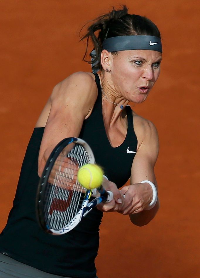 Lucie Safarova of the Czech Republic hits a return to Mandy Minella of Luxembourg during their women's singles match at the French Open tennis tournament at the Roland Ga