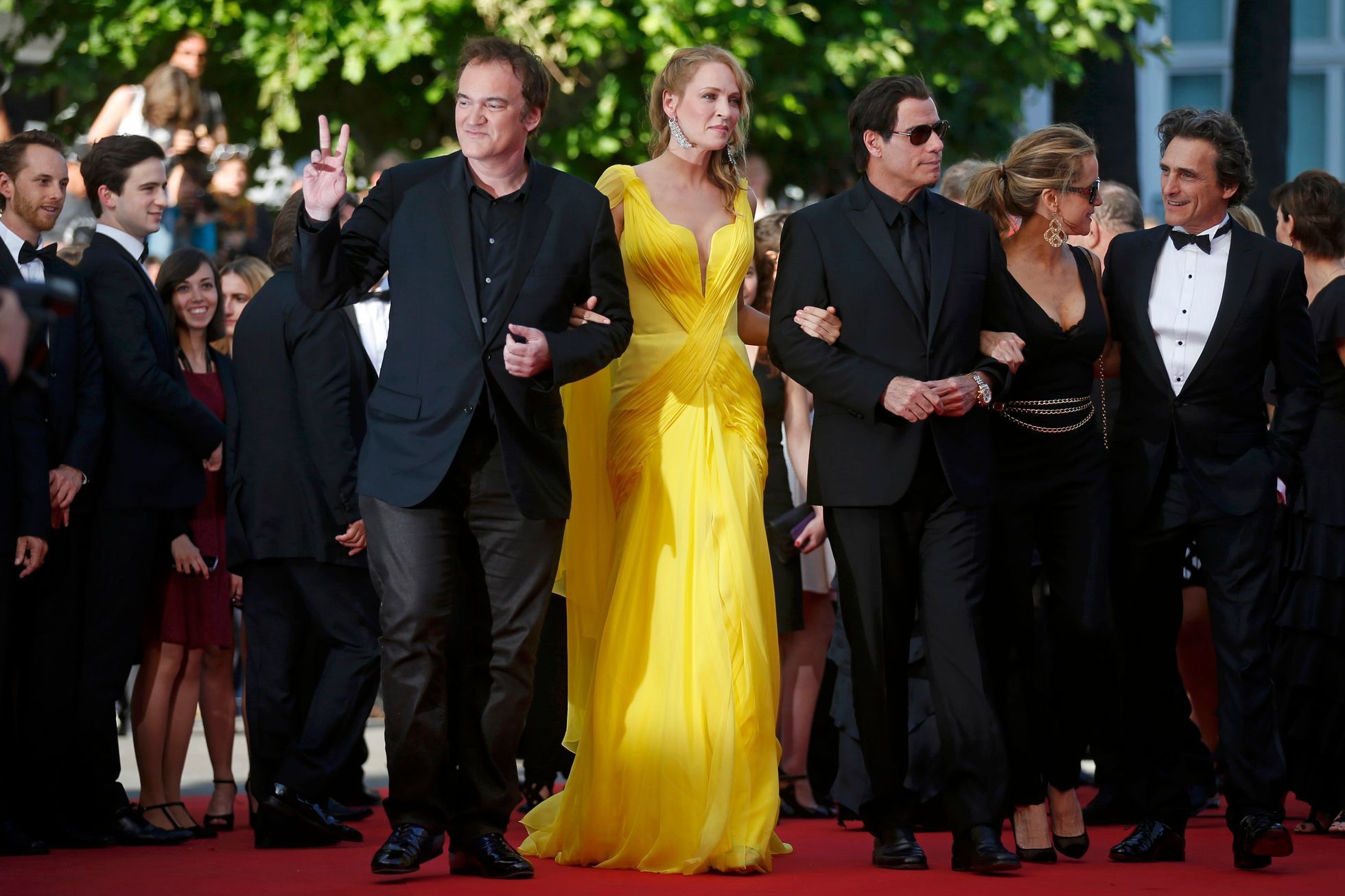 Director Quentin Tarantino, actress Uma Thurman and actor John Travolta pose on the red carpet they arrive for the screening of the film &quot;Sils Maria&quot; in competition at the 67th Cannes Film F