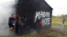 Runners emerge from the smoke house on the "Run for Your Lives" 5K obstacle course race in Amesbury, Massachusetts May 5, 2012. Runners face man-made and natural obstacles on the course, while being chased by zombies, who try to take "health" flags off the runners belts. REUTERS/Brian Snyder (UNITED STATES - Tags: SPORT SOCIETY) Published: Kvě. 5, 2012, 11:27 odp.