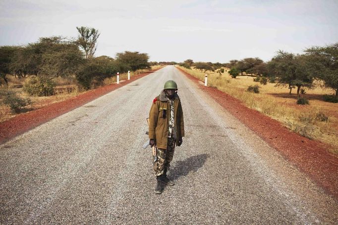 ¨ Malian soldier Ousmane Cisse stands guard on an open road outside Sevare, Mali, January 27, 2013. REUTERS/Joe Penney (MALI - Tags: MILITARY POLITICS CONFLICT) Published: Led. 27, 2013, 4:42 odp.