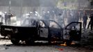 Protesters set a police vehicle on fire during clashes with riot police along a road which leads to the U.S. embassy, near Tahrir Square in Cairo September 13, 2012. Egypt's President Mohamed Mursi said on Thursday he supported peaceful protests but not attacks on embassies, after Egyptians angry at a film deemed insulting to the Prophet Mohammad climbed into the U.S. embassy in Cairo and tore down the U.S. flag. He pledged to protect foreigners in Egypt.