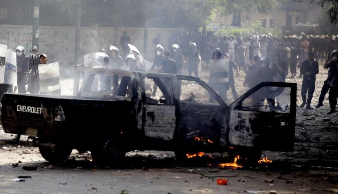 Protesters set a police vehicle on fire during clashes with riot police along a road which leads to the U.S. embassy, near Tahrir Square in Cairo September 13, 2012. Egypt's President Mohamed Mursi said on Thursday he supported peaceful protests but not attacks on embassies, after Egyptians angry at a film deemed insulting to the Prophet Mohammad climbed into the U.S. embassy in Cairo and tore down the U.S. flag. He pledged to protect foreigners in Egypt.