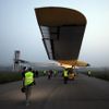 The Solar Impulse aircraft is being pulled out of the hangar for take off at Payerne airport May 24, 2012. The Solar Impulse HB-SIA prototype aircraft, which has 12,000 solar cells built into its 64.3 metres (193 feet) wings, attempted its first intercontinental flight from Payerne to Rabat in Morocco with a few days for a technical stop and a change of pilot in Madrid. This flight will act as a final rehearsal for the 2014 round-the-world flight. REUTERS/Denis Balibouse (SWITZERLAND - Tags: TRANSPORT SCIENCE TECHNOLOGY SOCIETY) Published: Kvě. 24, 2012, 7:25 dop.