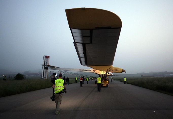 The Solar Impulse aircraft is being pulled out of the hangar for take off at Payerne airport May 24, 2012. The Solar Impulse HB-SIA prototype aircraft, which has 12,000 solar cells built into its 64.3 metres (193 feet) wings, attempted its first intercontinental flight from Payerne to Rabat in Morocco with a few days for a technical stop and a change of pilot in Madrid. This flight will act as a final rehearsal for the 2014 round-the-world flight. REUTERS/Denis Balibouse (SWITZERLAND - Tags: TRANSPORT SCIENCE TECHNOLOGY SOCIETY) Published: Kvě. 24, 2012, 7:25 dop.