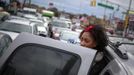 A girl looks toward a gas station as she and her parents wait with hundreds of others for over three hours to fuel up their vehicles in the New York City borough of Queens on November 1, 2012. A fuel supply crisis stalling the New York City area's recovery from Hurricane Sandy and reviving memories of the 1970s gasoline shortages stem from multiple factors, ranging from flooding to power outages to a diesel spill. REUTERS/Adrees Latif (UNITED STATES - Tags: DISASTER ENVIRONMENT ENERGY) Published: Lis. 1, 2012, 8:49 odp.