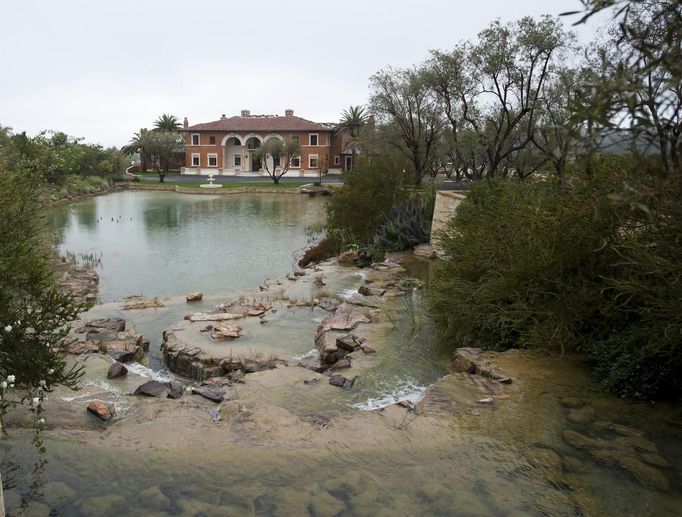 A $37 million dollar luxury home that is for sale at One Pelican Hill Road North is seen in Newport Beach, California April 13, 2012. It has 17 bathrooms, a 17-car garage, marbled floors, gold leaf ceilings, a vineyard, horse stables, tennis courts and a lake - and occupies the largest parcel of residential real estate on southern California's exclusive Newport Coast. This empty, never-sold, soon-to-be-auctioned mega-mansion is a gaudy symbol of the runaway extravagance that gripped the top end of the U.S. real estate market before the housing crash of 2008. Once valued at $87 million, it could be sold for a quarter of that price at an auction next week. Picture taken April 13, 2012. REUTERS/Lori Shepler (UNITED STATES - Tags: BUSINESS REAL ESTATE)