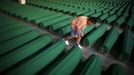 A Bosnian Muslim child searches for his relative's coffin which was prepared for a mass burial at the Memorial Center in Potocari, near Srebrenica July 9, 2012. The bodies of 520 recently identified victims of the Srebrenica massacre will be buried on July 11, the anniversary of the massacre when Bosnian Serb forces commanded by Ratko Mladic slaughtered 8,000 Muslim men and boys and buried them in mass graves, in Europe's worst massacre since World War Two. REUTERS/Dado Ruvic (BOSNIA - Tags: POLITICS CONFLICT ANNIVERSARY) Published: Čec. 9, 2012, 6:23 odp.