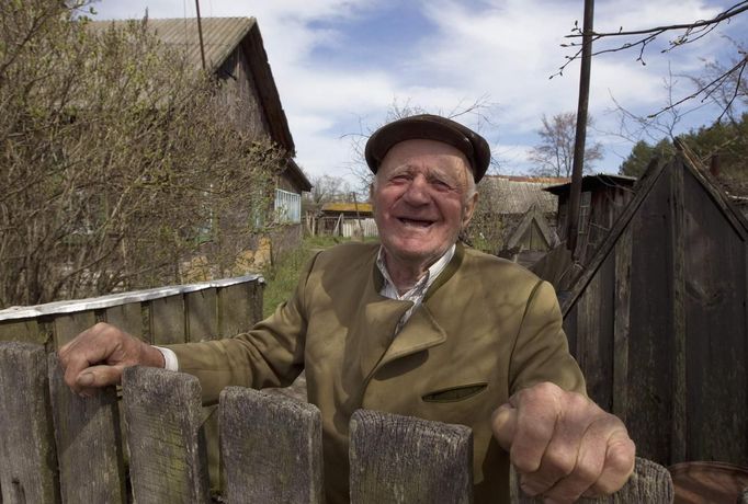 Villager Shamianok poses for picture at his house in abandoned village of Tulgovichi