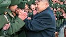 In this undated photo released by the Korean Central News Agency and distributed in Tokyo by the Korea News Service on Jan. 25, 2012, North Korean new leader Kim Jong Un greets students at Mangyongdae Revolutionary School in Pyongyang, North Korea, on the occasion of Chinese New Year. Young Kim gets rock star treatment when he visits his troops, just as his father did. But while the late Kim Jong Il mostly stayed aloof in dark shades, his son holds hands and hugs. He seems to want to bond. (AP Photo/Korean Central News Agency via Korea News Service) JAPAN OUT UNTIL 14 DAYS AFTER THE DAY OF TRANSMISSION =@=