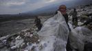 Garbage collectors look for recyclable waste at a municipal dump site in Tegucigalpa